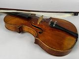 a violin that is sitting on a white surface