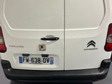 a white van parked in a showroom next to other vehicles