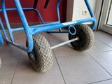 a blue cart that is sitting on the floor