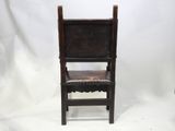 an old wooden chair with a leather seat on a white background