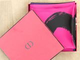 a close up of a pink box with a black and white logo