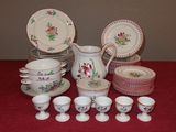 a table with a bunch of dishes and cups on it