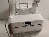 an image of a white radio sitting on top of a white floor