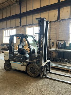 a forklift truck that is parked inside of a building