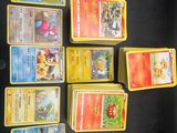 a lot of pokemon cards that are on the table