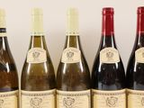 several bottles of wine are lined up on a table