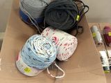several balls of yarn are sitting in a box on a table