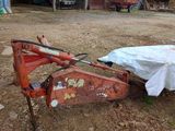 un tracteur qui est à l'arrêt dans la terre, recouvert d'une bâche