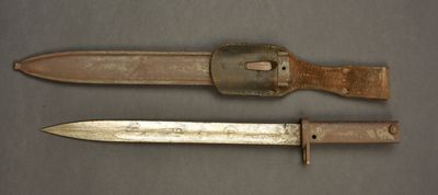 two old knives are sitting on a table next to each other