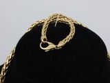 an image of a gold necklace and bracelet on a mannequin