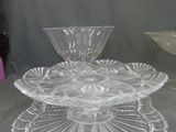 three glass dishes on a table with a bowl on top of it