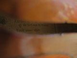 someone is cutting a piece of bread with a knife on top of it