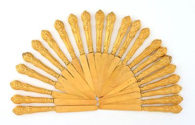 a gold fan that is sitting on a white surface