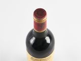 bottle of red wine on a white surface with a white background