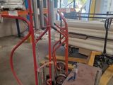 a hand truck with a cart in the middle of a warehouse