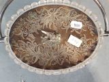 a glass bowl with a handle and a tag on it