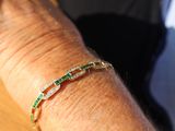 a close up of a person ' s arm with a bracelet
