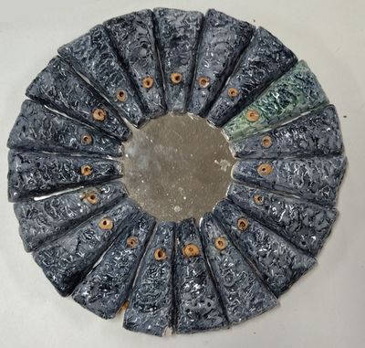 a circular mirror that has been made out of marble