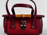 the small red bag is sitting on a white surface