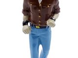 figurine of a man in a brown shirt and blue pants