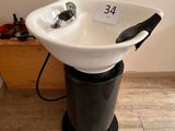 a black and white sink with a black handle on it