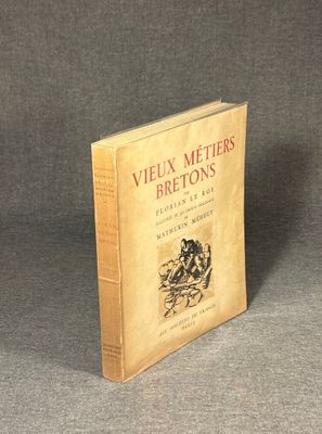 an old book sitting on top of a table on a gray surface