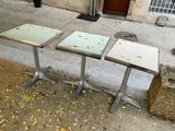 two tables that are sitting on the side of the street
