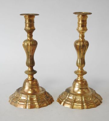 pair of antique brass candlesticks on a white background