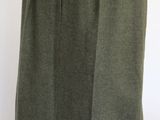 the skirt is made of wool and has buttons on the front