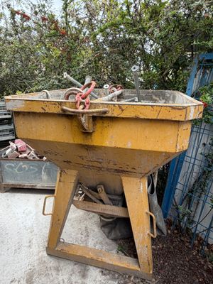a large yellow wheelbarrow that is sitting in a yard