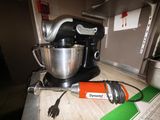 a mixer on the counter with a cord attached to it