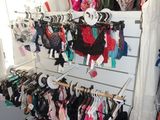 a lot of clothes hanging on a rack in a room