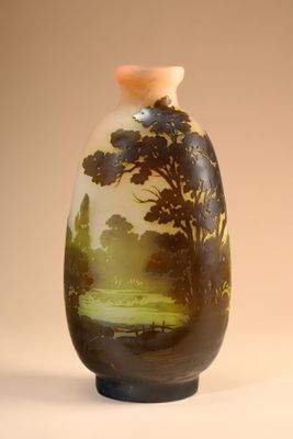 a vase with a painting on it sitting on a table