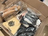 a cardboard box filled with assorted items sitting on a table