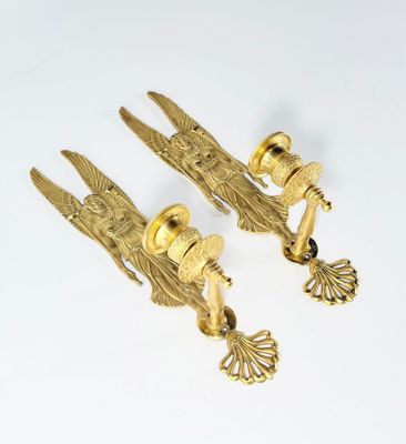 pair of antique brass door handles with eagle heads on them