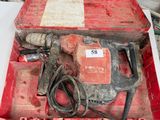 une boîte à outils rouge contenant un marteau et d'autres outils