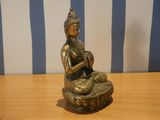 a small statue of a person sitting on a table