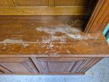 a wooden cabinet that has some dirt on it