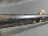 a close up of a metal pipe with a piece of wood sticking out of it