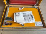 a suitcase that is open on the floor next to a bag of luggage