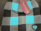 a knitted hat with a tag attached to it
