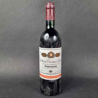 a bottle of red wine sitting on top of a table