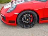 a red sports car parked on the side of the road