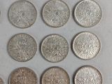 six different types of coins on a white surface