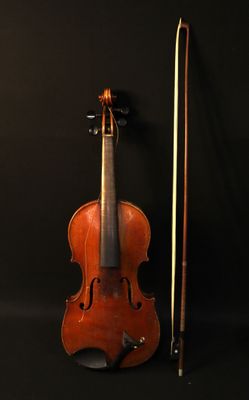 an old violin with a bow and bow rest on a black background