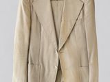 an image of a beige jacket hanging on a hanger