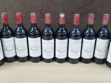 a group of bottles of wine sitting on top of a wooden table