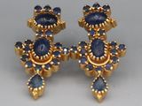 a pair of gold and sapphire earrings