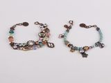 pair of multicolored beaded bracelets on a white surface