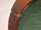 a wooden chair with a green seat and a green cushion